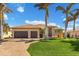 Tan house with brown garage doors and a paved driveway at 1002 Messina Dr, Punta Gorda, FL 33950