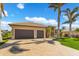 Tan house with brown garage doors and a large paved driveway at 1002 Messina Dr, Punta Gorda, FL 33950