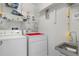 Bright laundry room with washer, dryer and shelving at 101 N Marion Ct # 221, Punta Gorda, FL 33950