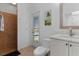 Bathroom with toilet, vanity, and door to outside at 11 Sabal Dr, Punta Gorda, FL 33950