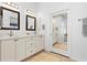 Double vanity bathroom with a large mirror and sliding barn door at 11 Sabal Dr, Punta Gorda, FL 33950