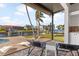 Relaxing canal view from screened patio, featuring lounge chairs and glimpses of boats at 11 Sabal Dr, Punta Gorda, FL 33950