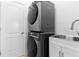 Laundry room with stacked washer and dryer, and a utility sink at 11 Sabal Dr, Punta Gorda, FL 33950