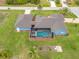 Aerial view of house with pool and landscaped yard at 124 Beau Rivage Dr, Rotonda West, FL 33947