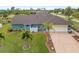 Light blue home with a brown tile roof and palm trees at 124 Beau Rivage Dr, Rotonda West, FL 33947