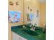 Green vanity with sink in an updated bathroom at 124 Beau Rivage Dr, Rotonda West, FL 33947