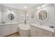 Elegant bathroom with double vanity, soaking tub, and marble countertops at 124 Beau Rivage Dr, Rotonda West, FL 33947