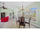 Bright dining area with a wood table, chairs, and large windows at 124 Beau Rivage Dr, Rotonda West, FL 33947