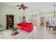 Spacious living room features light walls, wood floors, and a comfy red sofa at 124 Beau Rivage Dr, Rotonda West, FL 33947