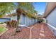 Landscaped side yard with rock and a palm tree at 124 Beau Rivage Dr, Rotonda West, FL 33947