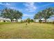 Spacious backyard with lush lawn and mature trees at 13284 Buckett Cir, Port Charlotte, FL 33981