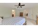 Bedroom with double bed and ceiling fan, offering views of the backyard at 13284 Buckett Cir, Port Charlotte, FL 33981