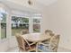 Bright breakfast nook with a round table and wicker chairs, overlooking the backyard at 13284 Buckett Cir, Port Charlotte, FL 33981