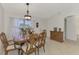 Dining area with wood table and chairs, sideboard, and entryway at 13284 Buckett Cir, Port Charlotte, FL 33981