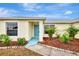 House entrance with light blue door, landscaping, and walkway at 13284 Buckett Cir, Port Charlotte, FL 33981