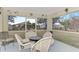 Relaxing screened porch with wicker furniture and backyard view at 13284 Buckett Cir, Port Charlotte, FL 33981