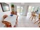 Bright dining room with table and chairs, access to backyard at 13323 Copper Ave, Port Charlotte, FL 33981