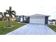 Two-car garage, white and gray exterior home at 13323 Copper Ave, Port Charlotte, FL 33981