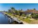 Aerial view of waterfront home with dock and lush landscaping at 1406 Mediterranean Dr, Punta Gorda, FL 33950