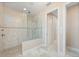 Walk-in shower with tile surround and glass enclosure at 1406 Mediterranean Dr, Punta Gorda, FL 33950