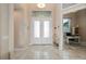 Bright and airy foyer with tile floors and access to an office at 1406 Mediterranean Dr, Punta Gorda, FL 33950