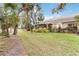 Landscaped backyard with house exterior at 1433 Red Oak Ln, Port Charlotte, FL 33948