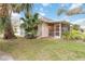 Landscaped backyard with screened porch at 1433 Red Oak Ln, Port Charlotte, FL 33948