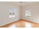 Bedroom with wood floors and two windows at 1433 Red Oak Ln, Port Charlotte, FL 33948