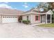 Exterior view of villa with attached garage and screened porch at 1433 Red Oak Ln, Port Charlotte, FL 33948