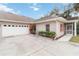 Exterior view of villa with attached garage and screened porch at 1433 Red Oak Ln, Port Charlotte, FL 33948