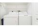 Laundry room with washer, dryer, and ample shelving at 1433 Red Oak Ln, Port Charlotte, FL 33948