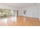 Bright living room with laminate floors, sliding glass doors, and a ceiling fan at 1433 Red Oak Ln, Port Charlotte, FL 33948