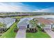 Single-story home with gray roof and attached garage, situated in a waterfront community at 15169 Spanish Point Dr, Port Charlotte, FL 33981