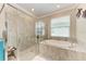 Spa-like bathroom with a soaking tub and walk-in shower at 15169 Spanish Point Dr, Port Charlotte, FL 33981