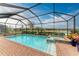 Inviting screened pool with spa and lake view at 15169 Spanish Point Dr, Port Charlotte, FL 33981