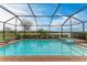 Refreshing screened pool and spa with lake view at 15169 Spanish Point Dr, Port Charlotte, FL 33981