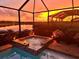 Relaxing spa and pool area with a stunning sunset view at 15169 Spanish Point Dr, Port Charlotte, FL 33981