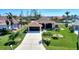 Aerial view of a canal front home with lush landscaping and a large backyard at 15706 Viscount Cir, Port Charlotte, FL 33981