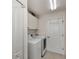 Laundry room with washer, dryer, and cabinets at 15706 Viscount Cir, Port Charlotte, FL 33981