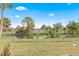 Spacious backyard with canal view, screened patio, and lush landscaping at 1638 Viscaya Dr, Port Charlotte, FL 33952