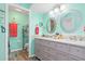 Bathroom boasts dual vanities, large mirrors and teal color scheme at 1638 Viscaya Dr, Port Charlotte, FL 33952