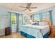 Main bedroom with king-size bed, wood ceiling and light teal walls at 1638 Viscaya Dr, Port Charlotte, FL 33952