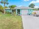 Light blue home with a garage and nicely landscaped yard at 1638 Viscaya Dr, Port Charlotte, FL 33952