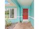 Red front door entry with teal colored walls at 1638 Viscaya Dr, Port Charlotte, FL 33952