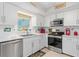 White kitchen with stainless steel appliances and a marble countertop at 1638 Viscaya Dr, Port Charlotte, FL 33952