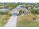 Aerial view of house with garage and landscaped yard at 18305 Wolbrette Cir, Port Charlotte, FL 33948