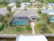 Aerial view showcasing home's pool, patio, and canal access at 18305 Wolbrette Cir, Port Charlotte, FL 33948