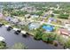 Aerial perspective of canal-side homes, showing pools and boat docks at 18305 Wolbrette Cir, Port Charlotte, FL 33948