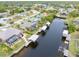 Wide aerial showcasing waterfront homes and canal at 18305 Wolbrette Cir, Port Charlotte, FL 33948