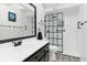 Modern bathroom with black vanity and glass shower at 18305 Wolbrette Cir, Port Charlotte, FL 33948